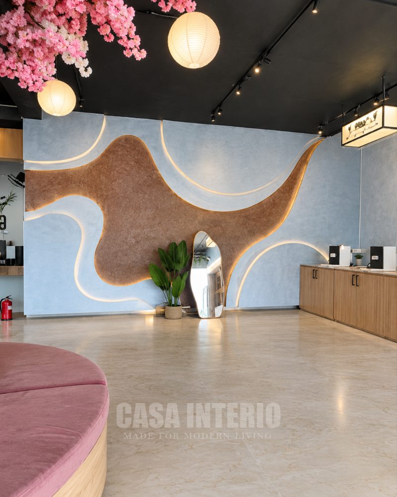Sculpted feature wall in cork and blue plaster with warm hidden lighting