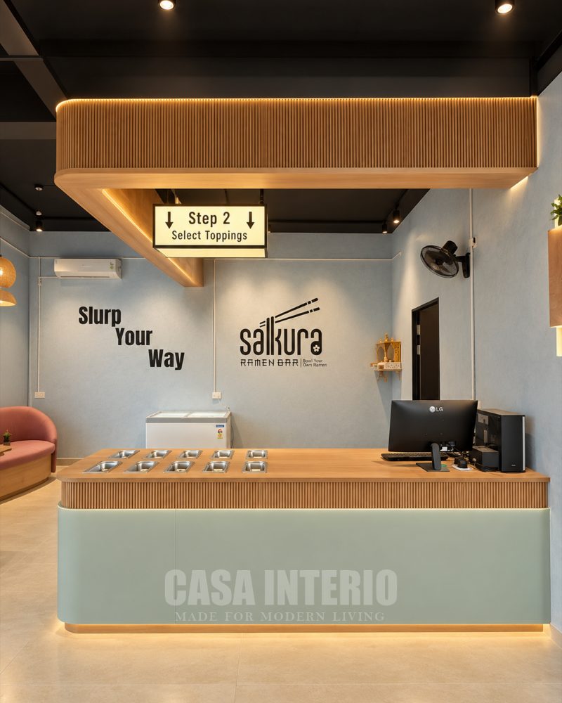 Toppings counter in fluted oak and sage with a lit oak canopy above