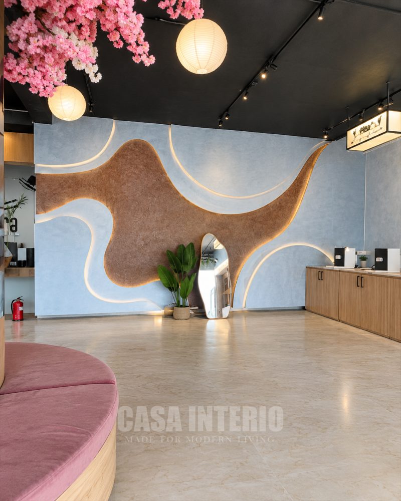 Organic mirror and plant against the sculpted cork and plaster wall